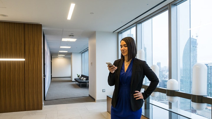 Female office worker looking at her phone