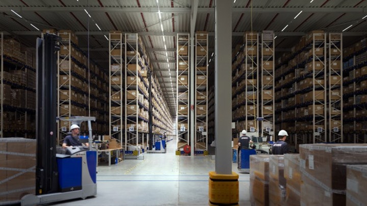 Warehouse staff controlling picking equipment