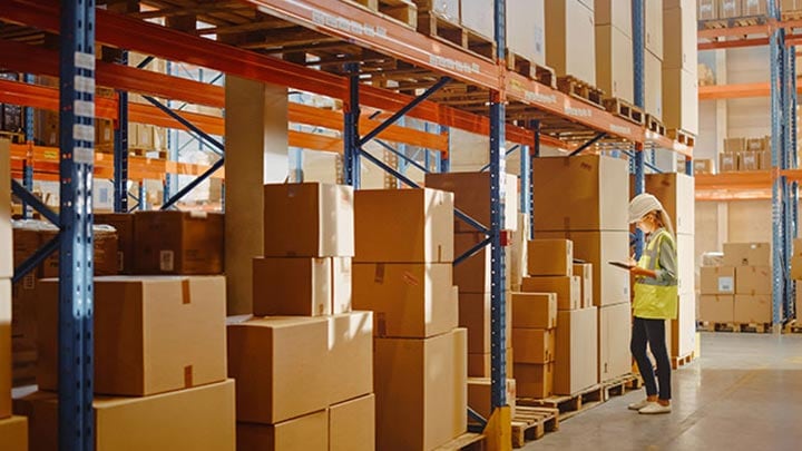 Cardboard boxes stacked on warehouse shelving