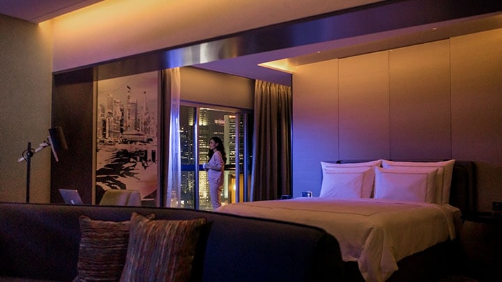 Woman relaxing in hotel room at night