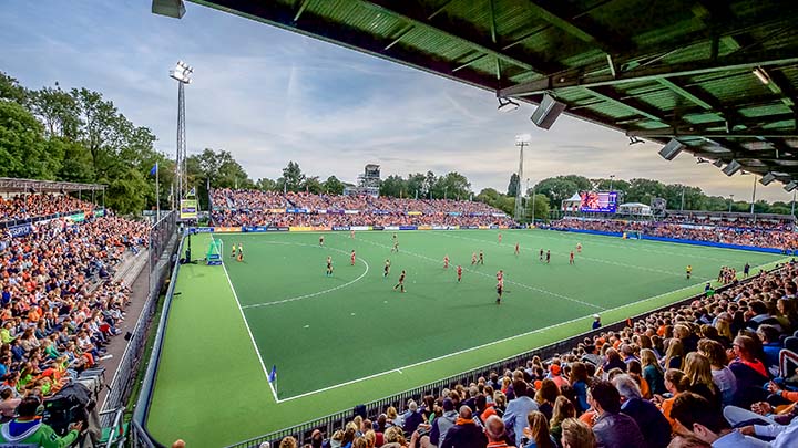 Outdoor hockey stadium with crowd