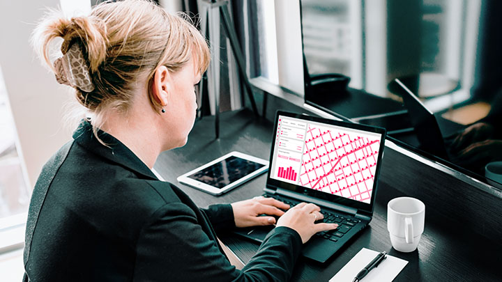 Woman on laptop in hotel