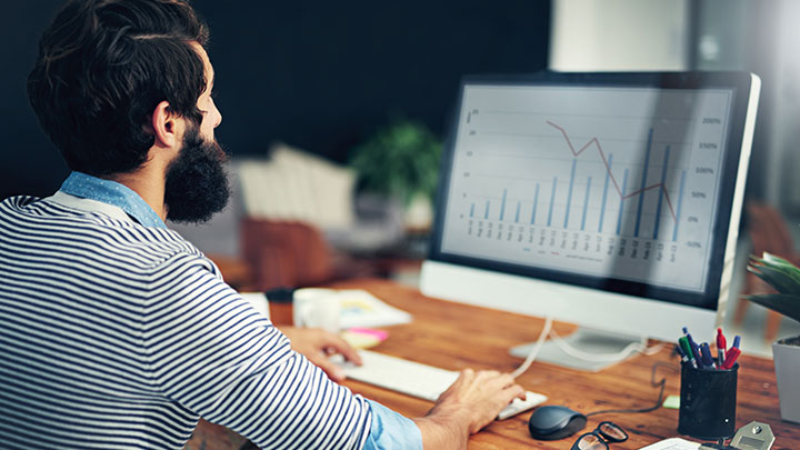 Man looking at dashboard on computer screen