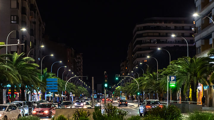 Busy city street lined with street lights at night