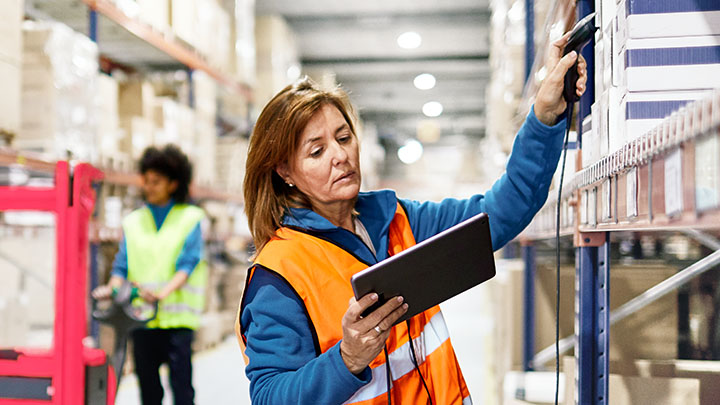 Warehouse workers scanning product on ipad