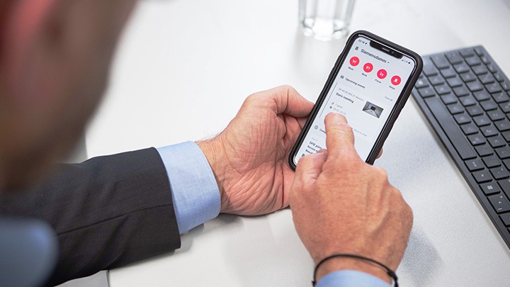 Man booking office meeting room on smart phone