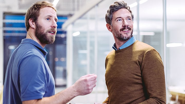 Two office workers discussing lighting in office