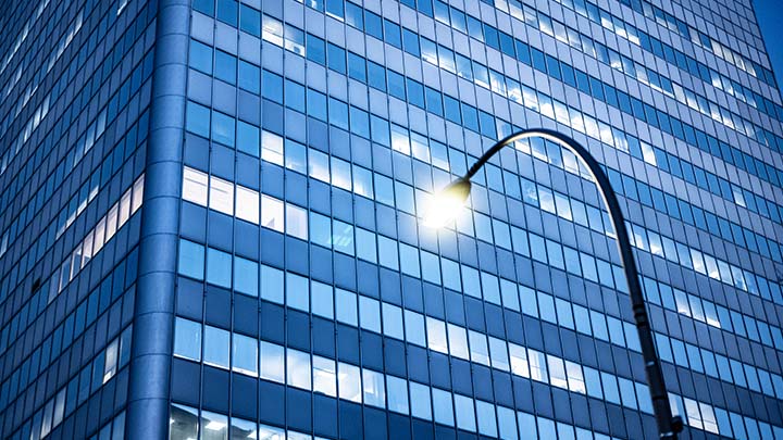 Streetlight in front of glass building