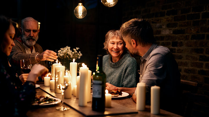 A family enjoying a candlelit dinner at a restaurant