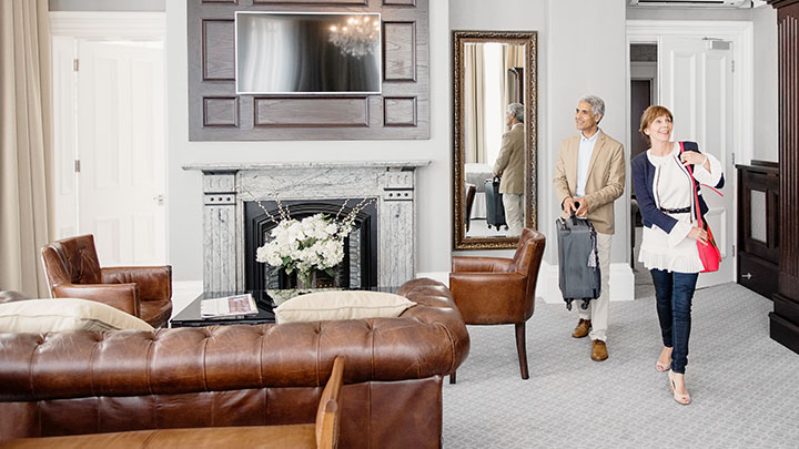 A couple walking into a contemporary hotel room