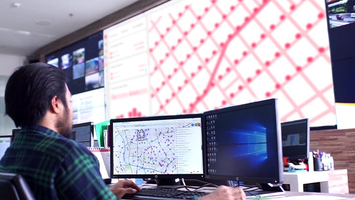 A worker controlling lighting infastructure from a control room