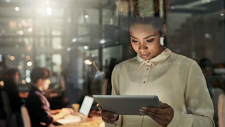 Woman using tablet to control lights