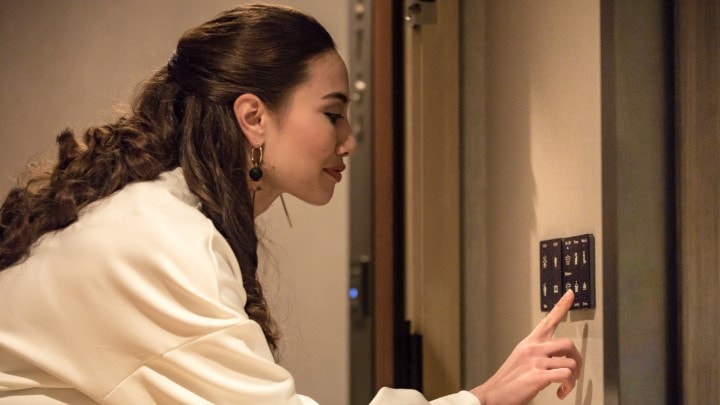 Hotel guest adjusting lighting in room